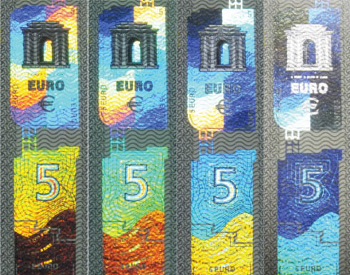 Figure 1 Diffractive structures on the €5 banknote. Four photographs were taken from a detail of the banknote. From one shot to the next, the incidence angle was changed so that different colors are perceived for the same areal position.