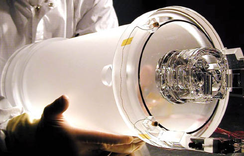Figure 1 Side view of the pre-flight prototype GP-B telescope made from fused silica. The actual flight version has clear sides. The overall cylindrical section is ∼43 cm long. Free of mechanical fasteners, the optics construction has over 40 bonding interfaces, which survive 2.5 K thermal cycling. Courtesy: Stanford University (http://einstein.stanford.edu/content/tech_stories/ts_11-telescope.html).