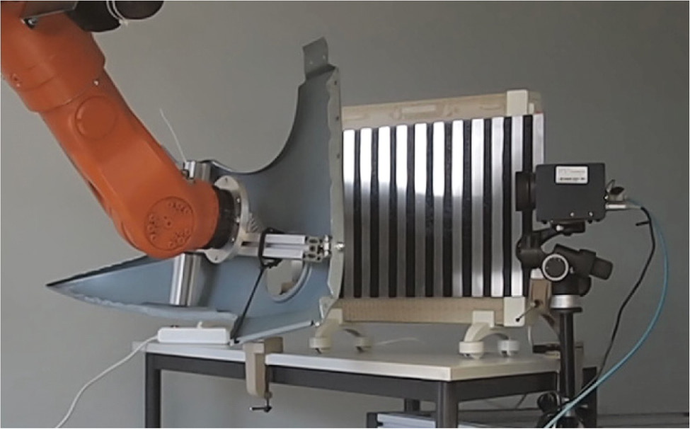 Figure 5: Laboratory setup for testing a car body part with fixed pattern that is translated in steps of a quarter of its period to implement a simple phase-shifting method. The low-emissivity carrier metal is aluminum in this case.