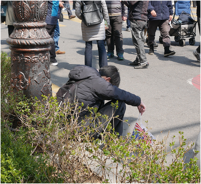 Photo 2: 
A young supporter of Yoon Seok-yeol stands demoralised on Sam-il Boulevard, Seoul, in the wake of the Constitutional Court’s verdict, 4 April 2025. © Adrian Gasser, April 2025.
