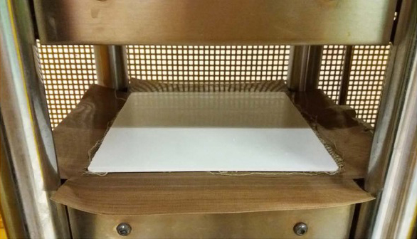 Figure 3 PP and linen fabric placed in the hot plate press for moulding.