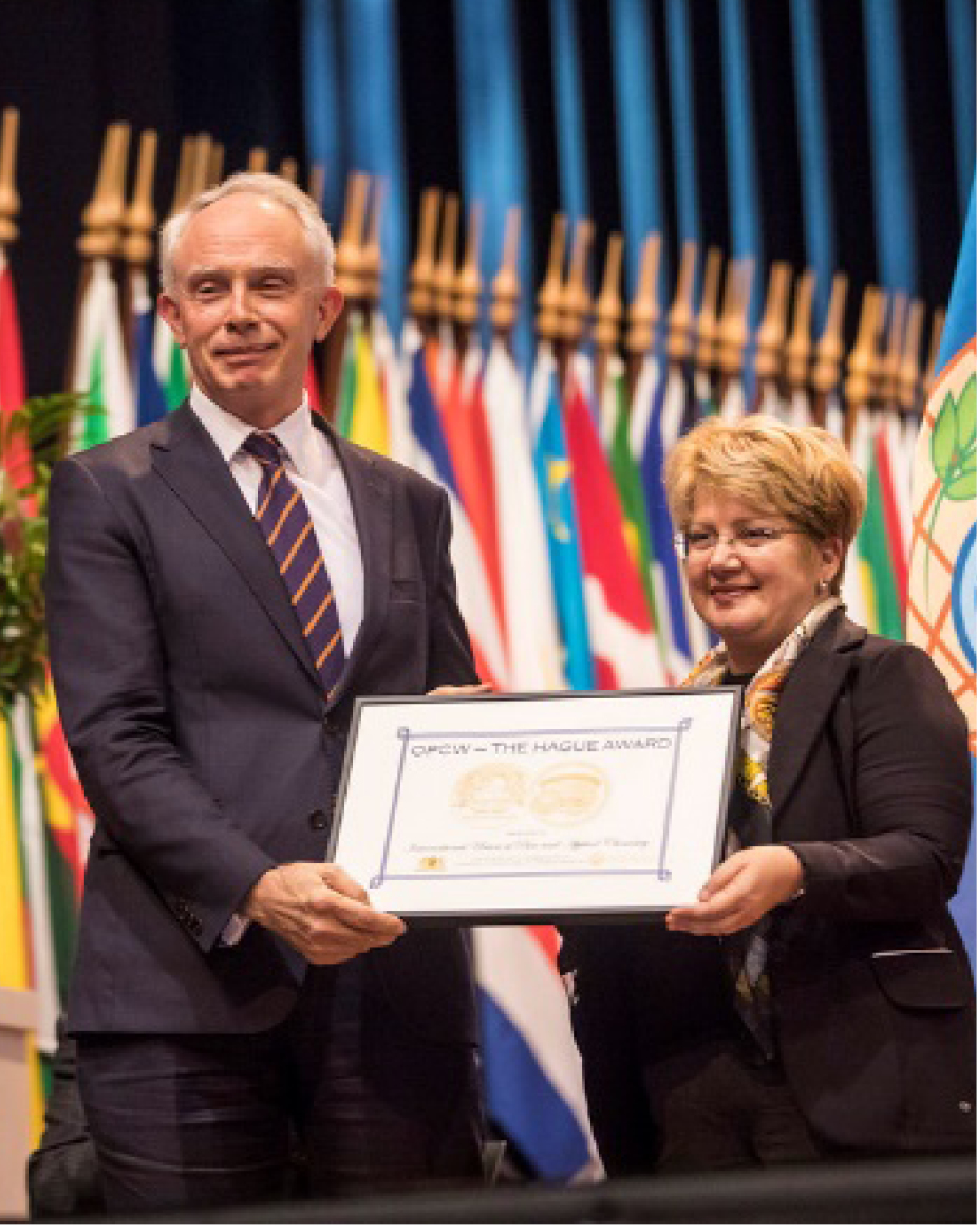  
          
            Chris Brett (left) received on behalf of IUPAC The Hague Award in 2019. See <https://iupac.org/iupac-is-one-of-the-recipients-of-the-2019-opcw-the-hague-award/> and more therein.
          
        