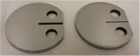 Figure 13: 
					Notched DC(T)-like specimens of 4140 steel before their EAC tests. Note the two different tip radii.
				