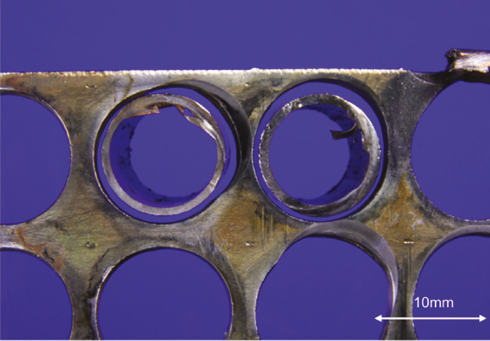 Figure 12: 
						Worn-out holes in a baffle plate.
						Reprinted from Klein et al. (2014), with permission from Elsevier.
					