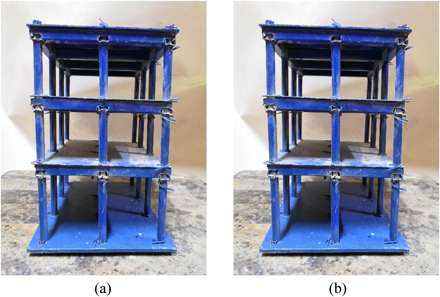 Figure 2 
                  Fabricated steel building frames used in the study: (a) examined three-storey building and (b) three-storey building.