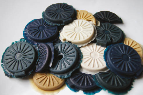 Figure 2: The picture of the obtained vulcanizates. White samples were cross-linked by dicumyl peroxide, light brown were cross-linked by sulfur. Dark blue samples contain chloroaluminum phthalocyanine, blue-green contain zinc phthalocyanine.
