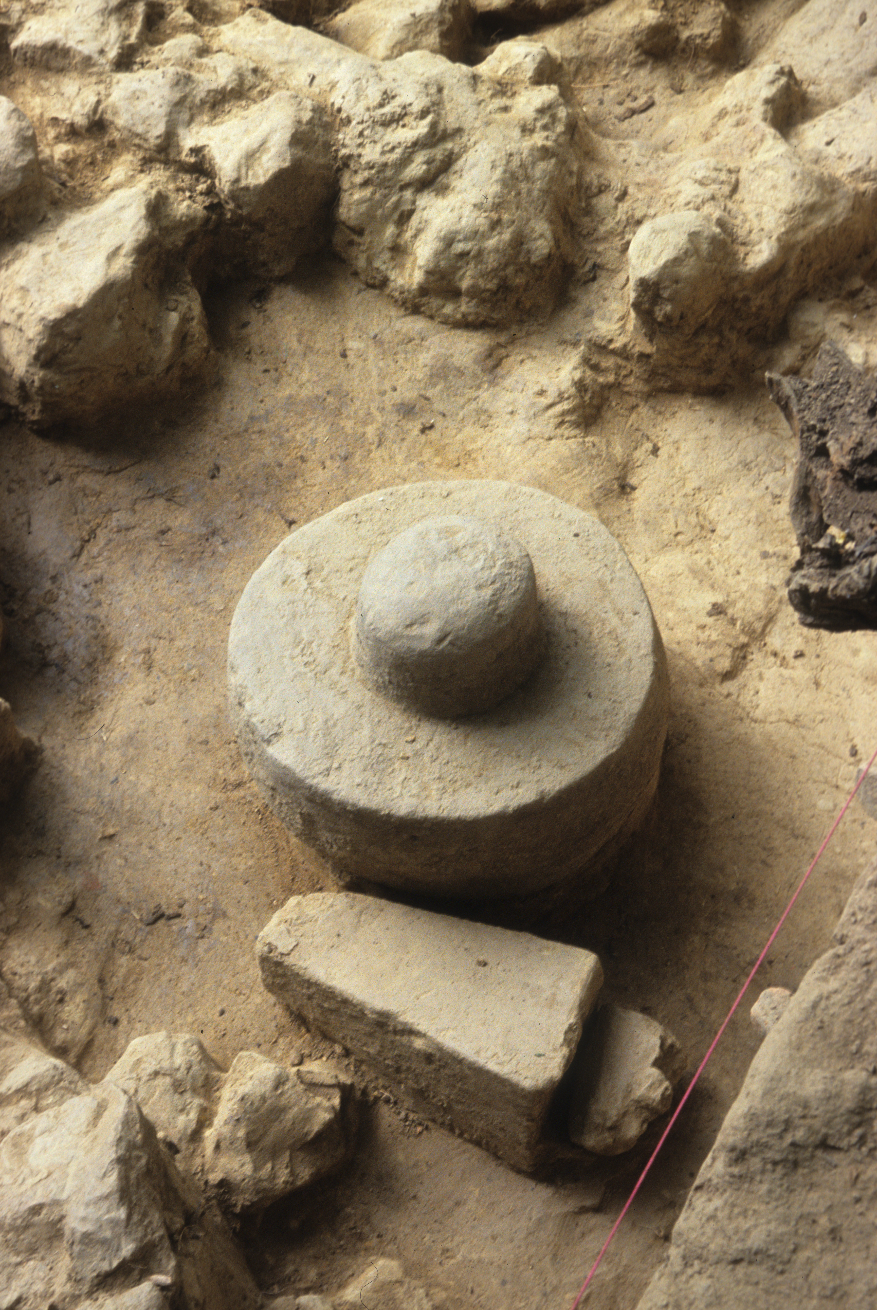 Fig. 8 Inscription Deposit: statue bases and sandstone cylinders in situ. Bottom left: Pyramidal inscribed base (PC 05–105); 2. Bottom right: Pentagonal base (PC 05–122); Center: Sandstone cylinder (PC 105–166). (Courtesy MVAP).