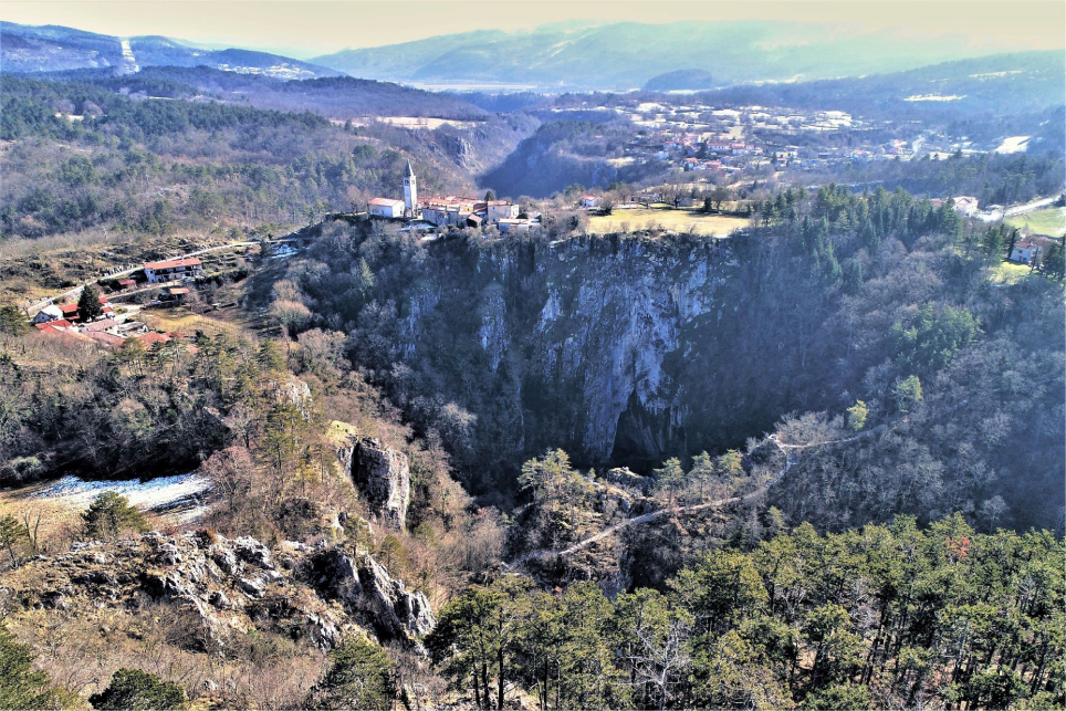 Figure 3 A collapse doline at Matavun settlement (SW Slovenia) above Škocjan Caves, one of the most attractive tourist caves in Slovenia.