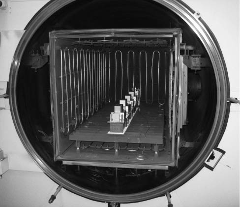 Figure 13 Stacks burdened with weights inside the vacuum oven.