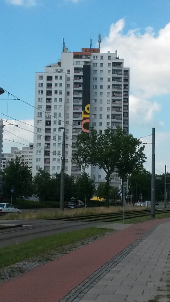 Figure 11 
            Picture by participant 11 featuring one of the tower blocks. In the front is a big road/tram line.
          