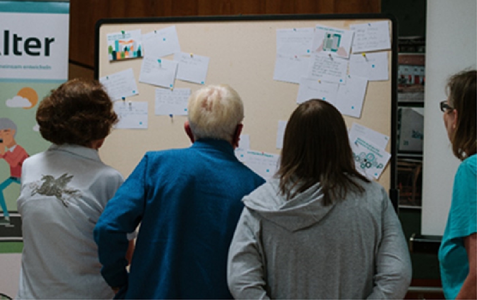 Figure 16 
            Participants discussing the postcards at a workshop.
          