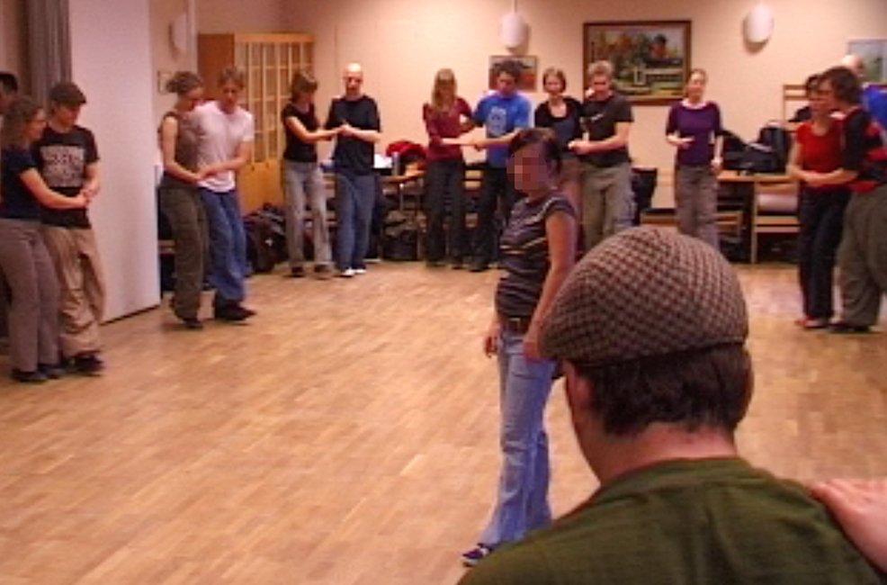 
Figure 2:
 

Teacher vocalizing in the middle of the circle, students dancing.

