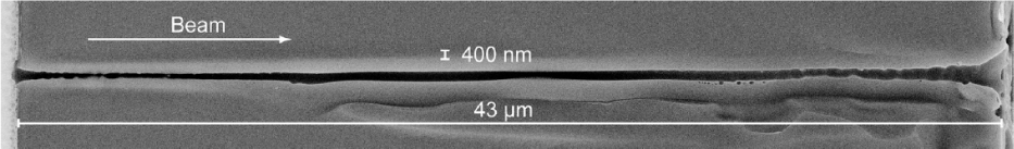 Figure 19 SEM image of a through channel with a diameter of about 400 nm formed in 43-μm thick glass (aspect ratio: > 100) by a femtosecond Bessel pulse [140]. Reproduced with permission from The American Institute of Physics, ©2010 by The American Institute of Physics.