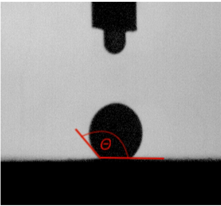 Figure 3 
Picture of 3 µl glue drop on paper surface taken by Fibro DAT 1100, with marked tangent fitting for contact angle measurement.

