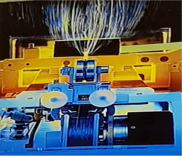 Figure 6 Picture of needleless electro-spinning device at the Textile Research Division, National Research Centre (TRD-NRC) and the jets during the electro-spinning experiment (40 kV nozzles, 13 cm distance, polyamide 6, in a mixture of formic acid and acetic acid)