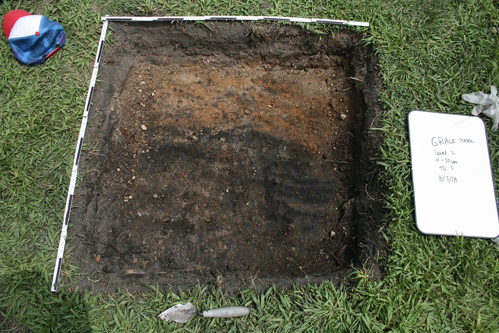 Figure 5 
                  Planview of test unit 5, facing east. Example of sandy, iron-rich subsoil in the top half of the unit floor.
               