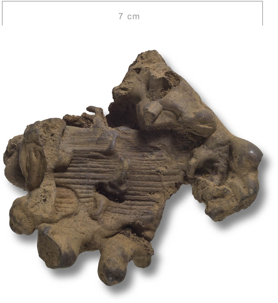 Figure 4
Stearin-like reduction slag from the iron production site in Vivungi, featuring well-preserved charcoal imprints (photograph by Staffan Nygren © Norrbottens museum).