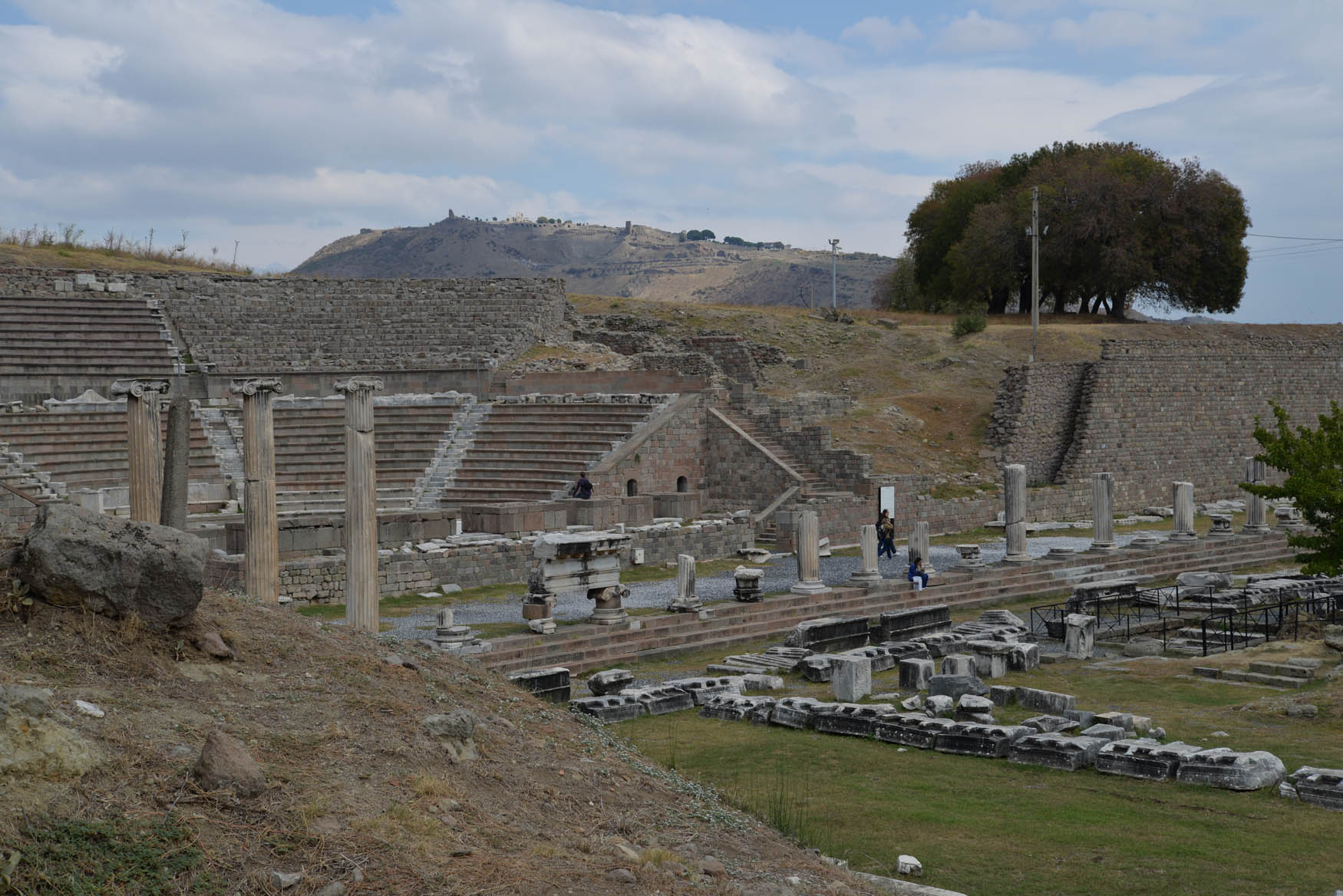 Figure 7
The cavea of the “Sacred Theater” and North Stoa, both of which abut the hillside. Pergamon is visible in the background (image: C. G. Williamson).