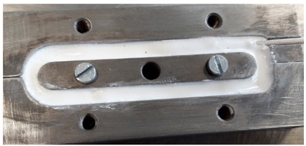 Figure 6 Stainless steel mold defining the shape of inorganic coils.