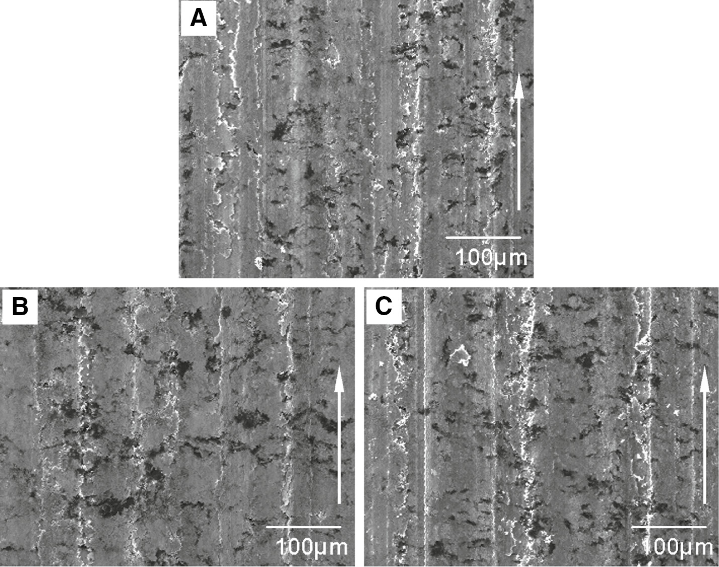 Figure 9: Scanning electron microscopy (SEM) micrographs of the worn surfaces of Cu-WS2-graphite-multi-wall WS2 nanotubes (Cu-WS2-G-WSNTs) at different sliding velocity with 2.5 N/cm2 of applied load and 10 A/cm2 of electrical current: (A) 5 m/s; (B) 10 m/s; (C) 15 m/s (arrows show the sliding direction).