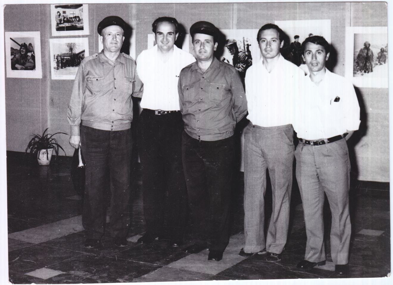 Figure 4: 
Army photographers posing on the occasion of a photographic exhibition, Tirana. Courtesy: Private collection, Tirana. Photographic exhibitions were an important means of disseminating photography, as was the illustrated press. The ambition of every photographer was to have the chance to mount a “personal exhibition”. Whether reflecting the activity of a whole department or a single individual, exhibitions were a source of pride and gave rise to rituals, such as posing in front of the exhibited prints.