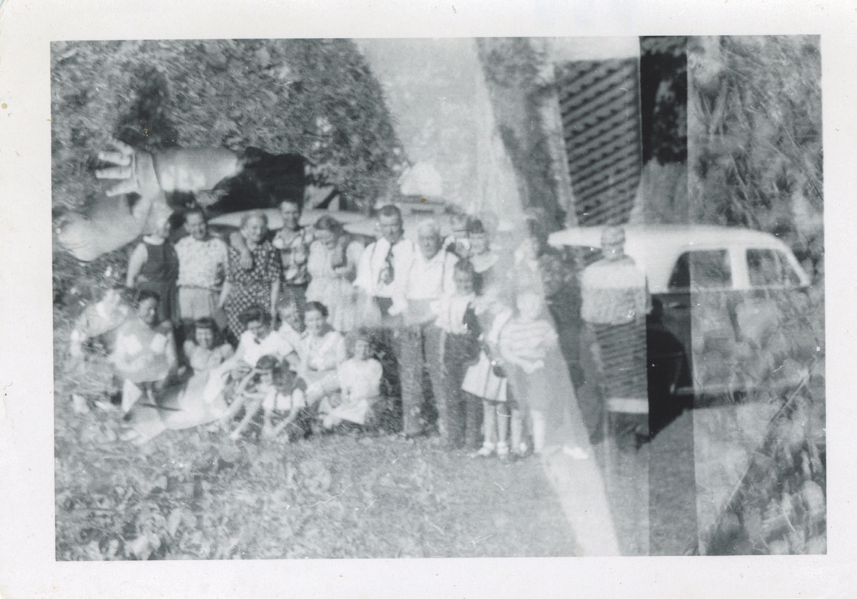 3 
A large group poses for a photo in front of three automobiles, photographer unknown, c. 1950s. Author’s personal collection